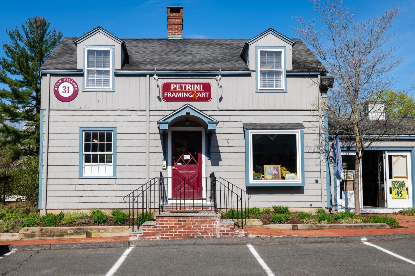 Petrini Framing & Art’s grey clapboard storefront in Old Avon Village