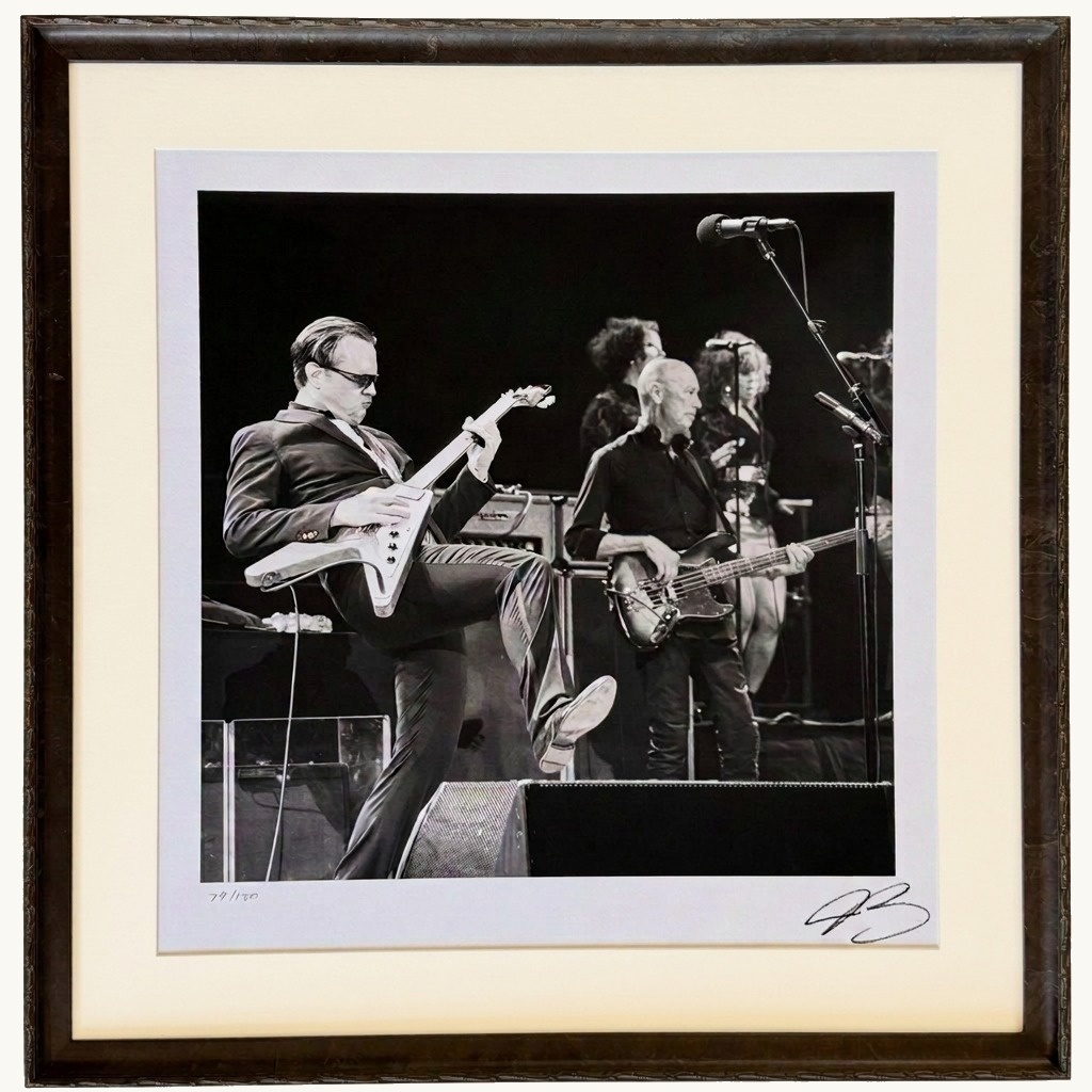 A signed, numbered Joe Bonamassa concert photograph in a dark carved frame